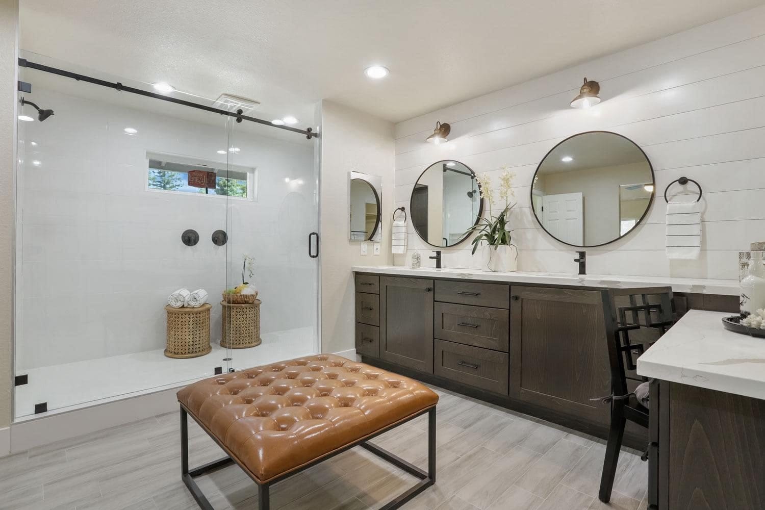 Custom espresso double bathroom vanity with quartz top and round mirrors in a Roseville primary bath