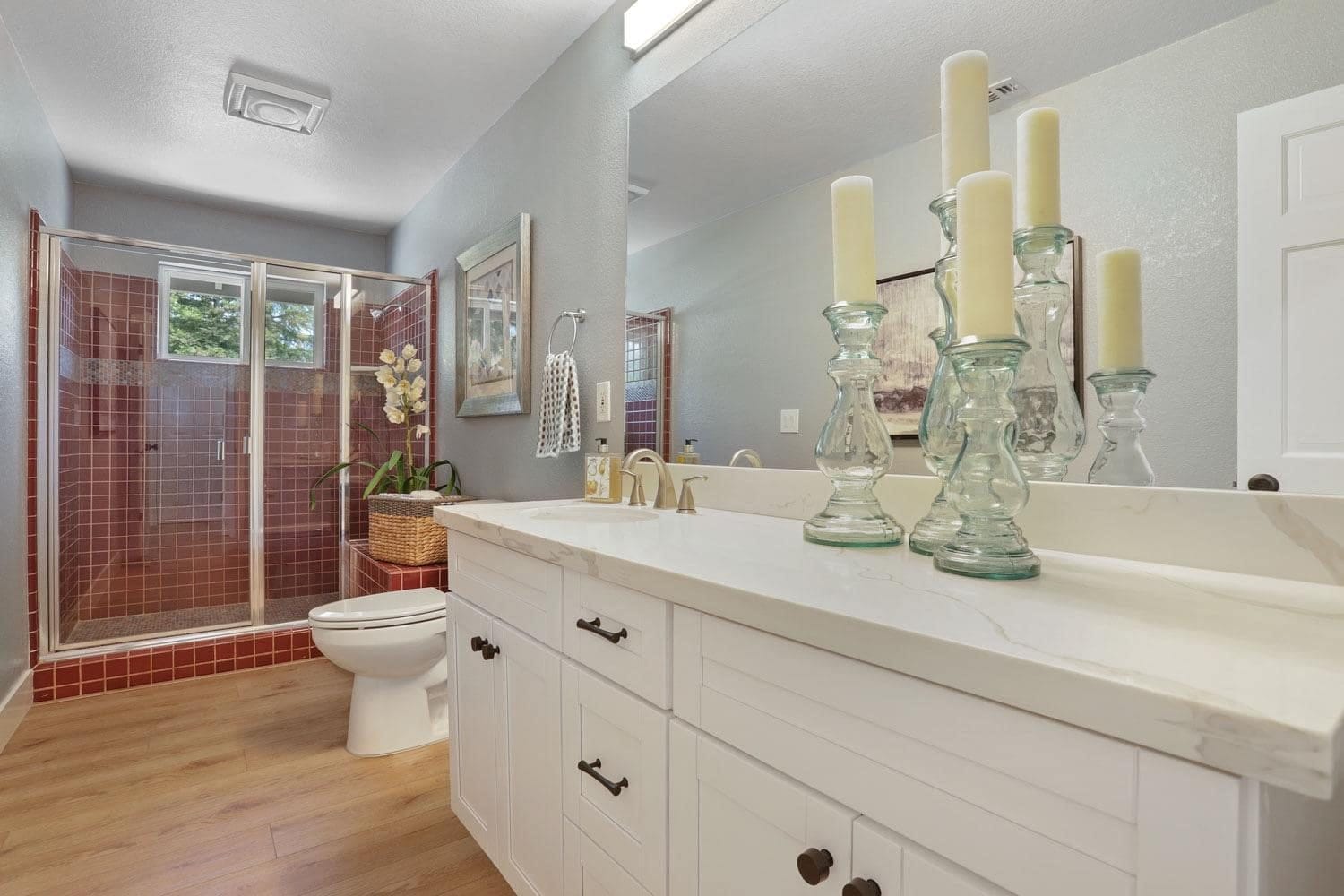 White painted shaker hall bathroom vanity with quartz top