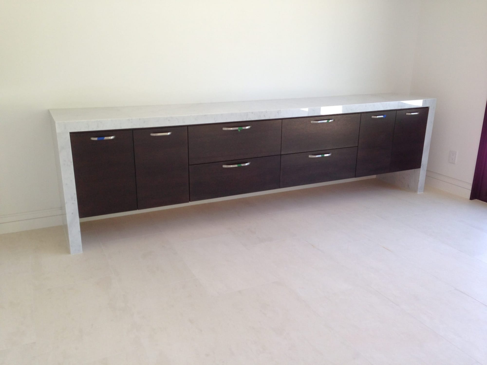 Floating espresso credenza with white quartz waterfall top