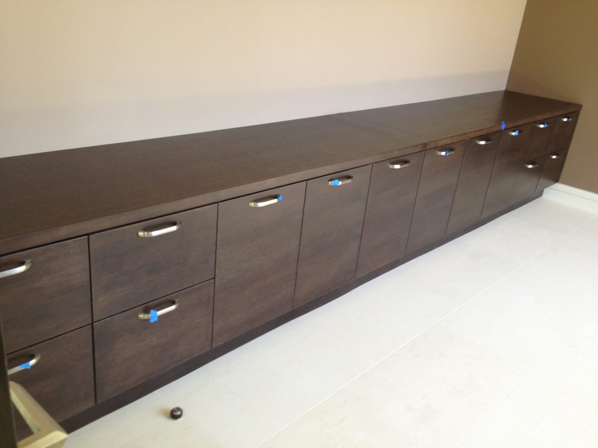 Espresso slab doors and drawers with brushed steel pulls