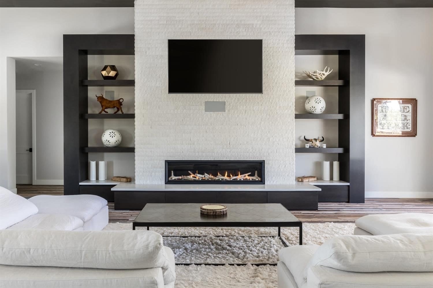 Custom fireplace media wall with espresso built-in shelving and cabinets in a Woodland, CA home